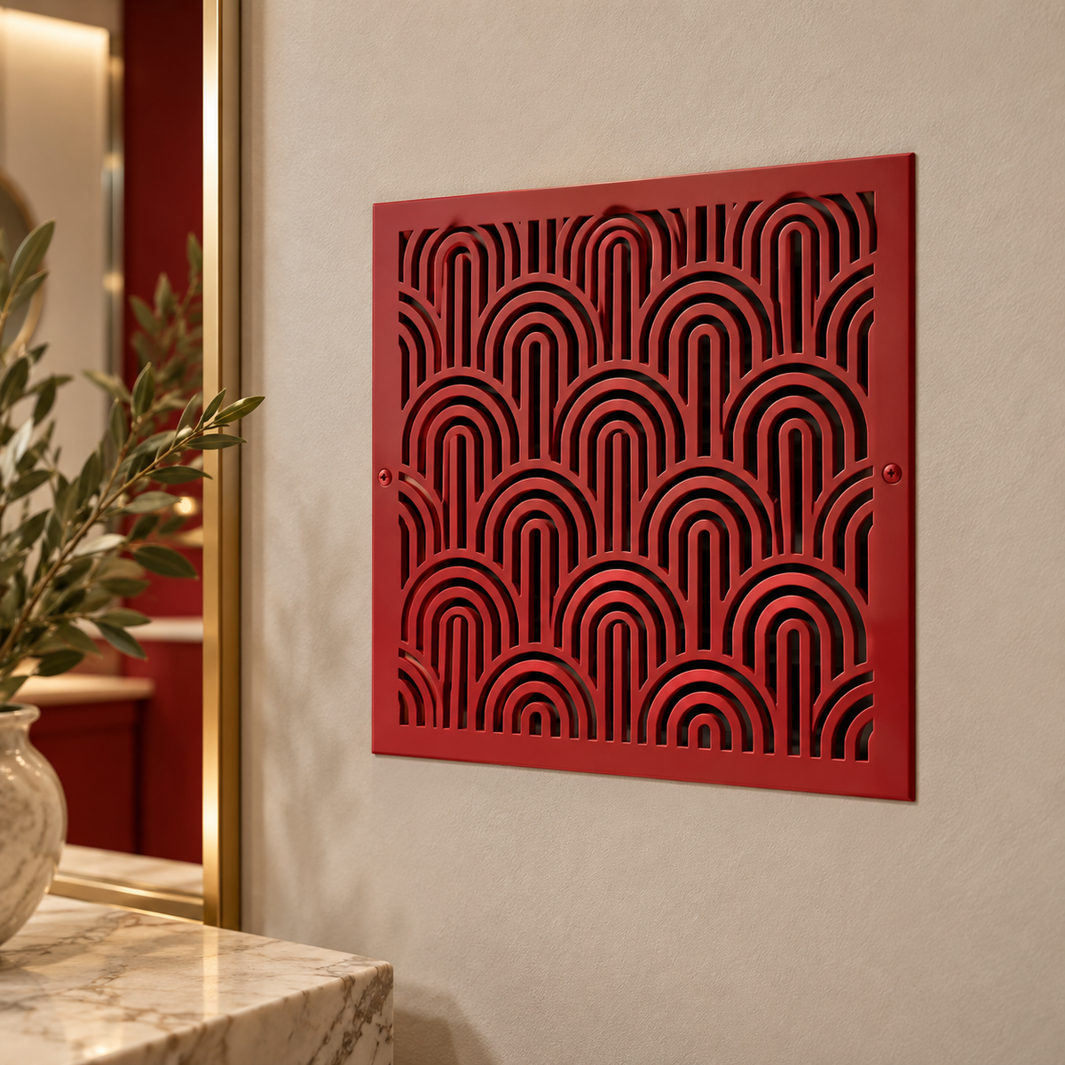 Red decorative metal wall vent cover with geometric arch pattern mounted on a beige wall in a modern interior.