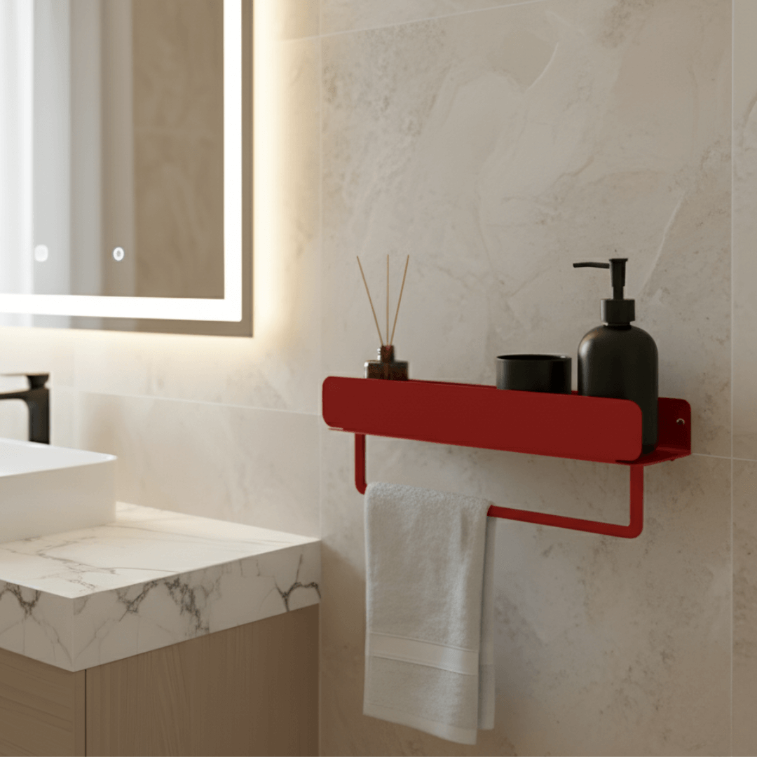 Bathroom with a red shelf holding a white towel, black bottle, and small plant against a marble wall.