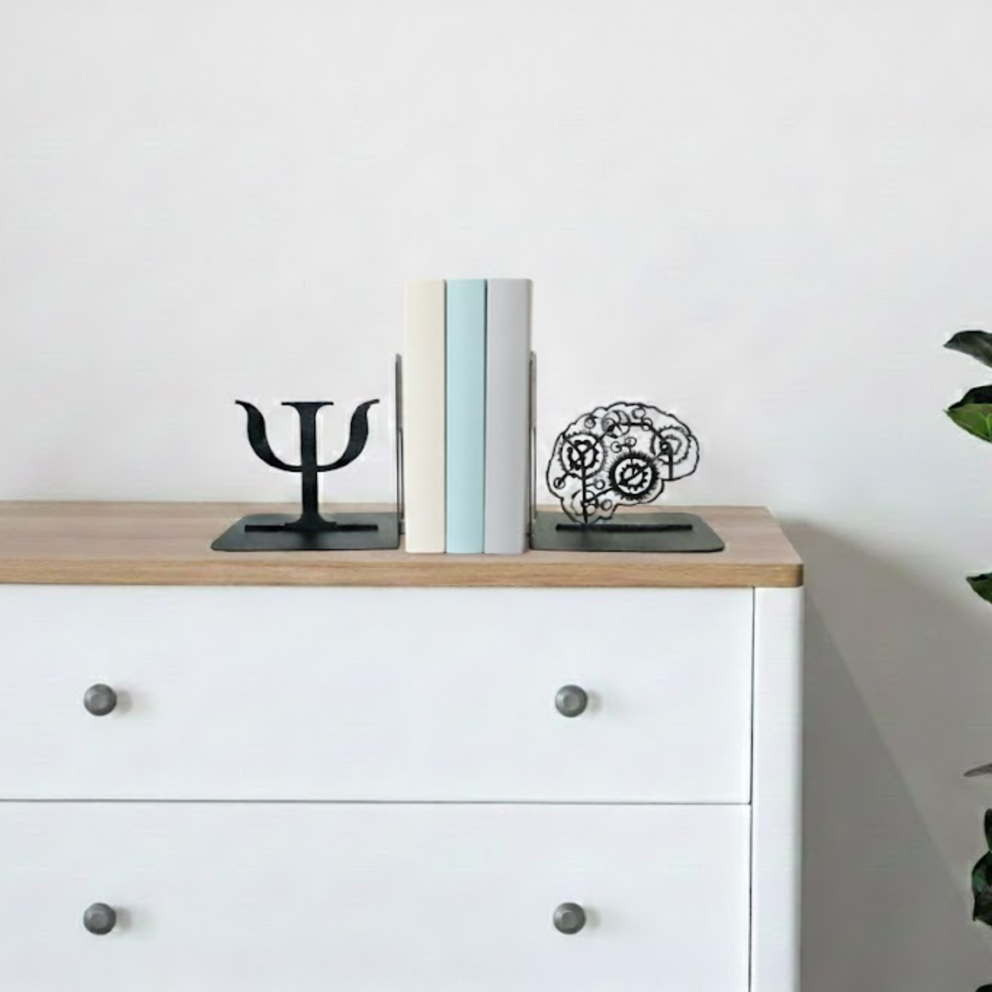 Decorative items on a wooden surface with a white cabinet in the background