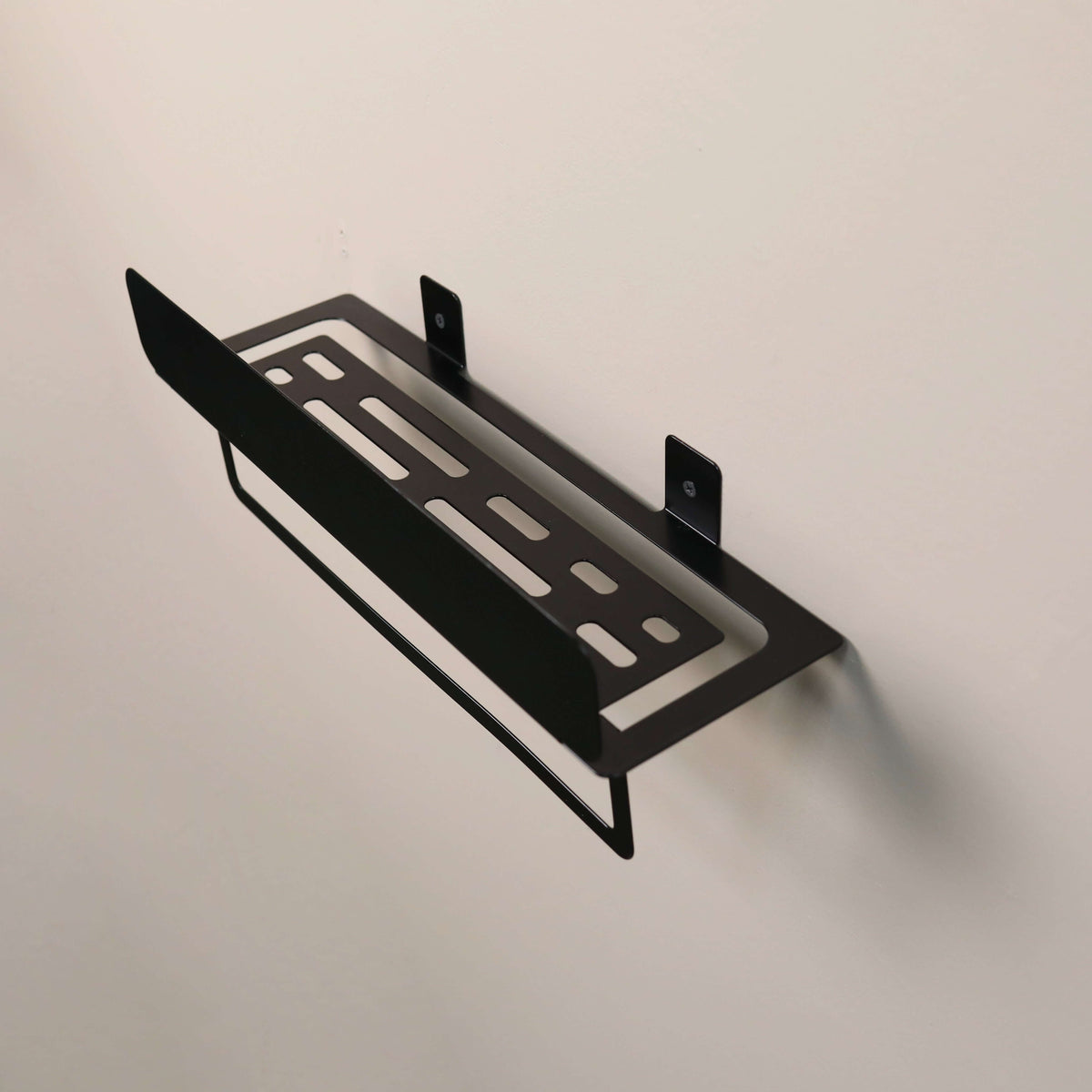 Black metal shelf bracket on a beige background