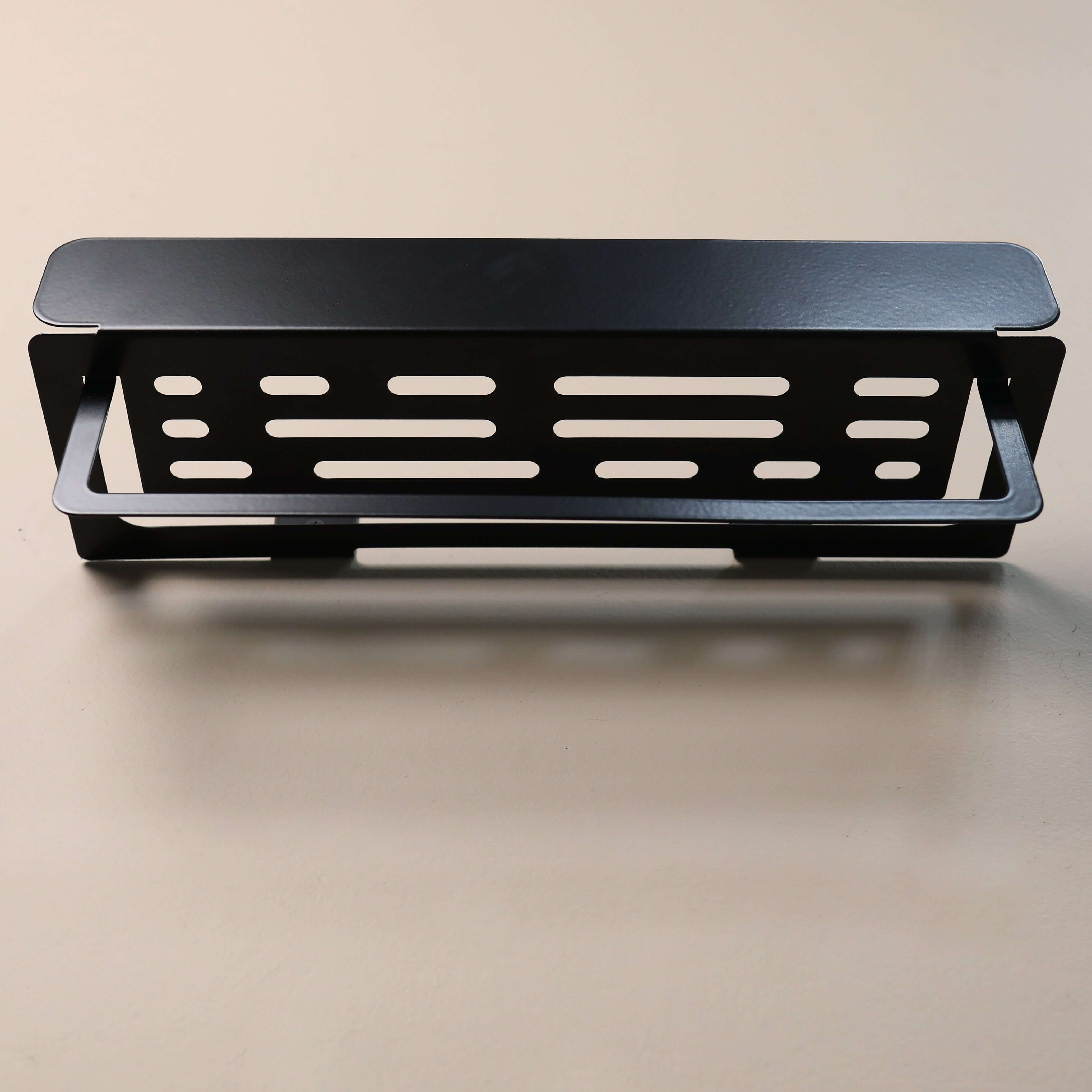 Black metal shelf on a beige background