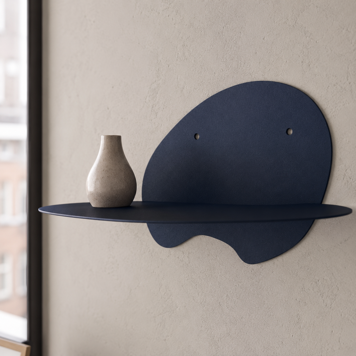  abstract metal floating wall shelf with curved back panel displaying a small succulent and notebook