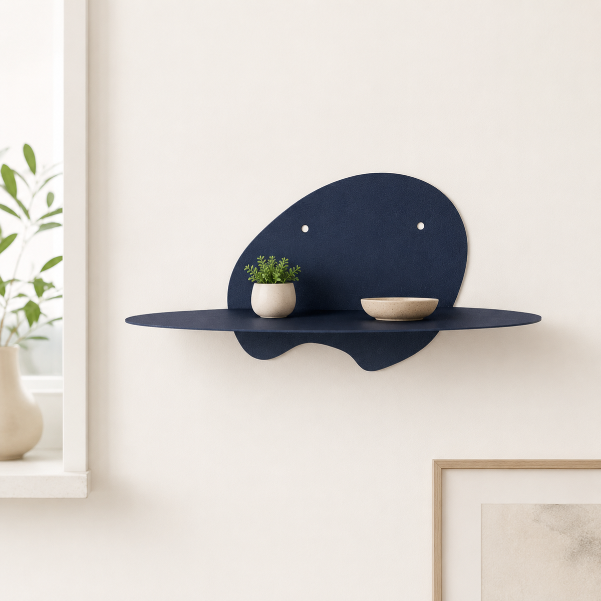  abstract metal floating wall shelf with curved back panel displaying a small succulent and notebook