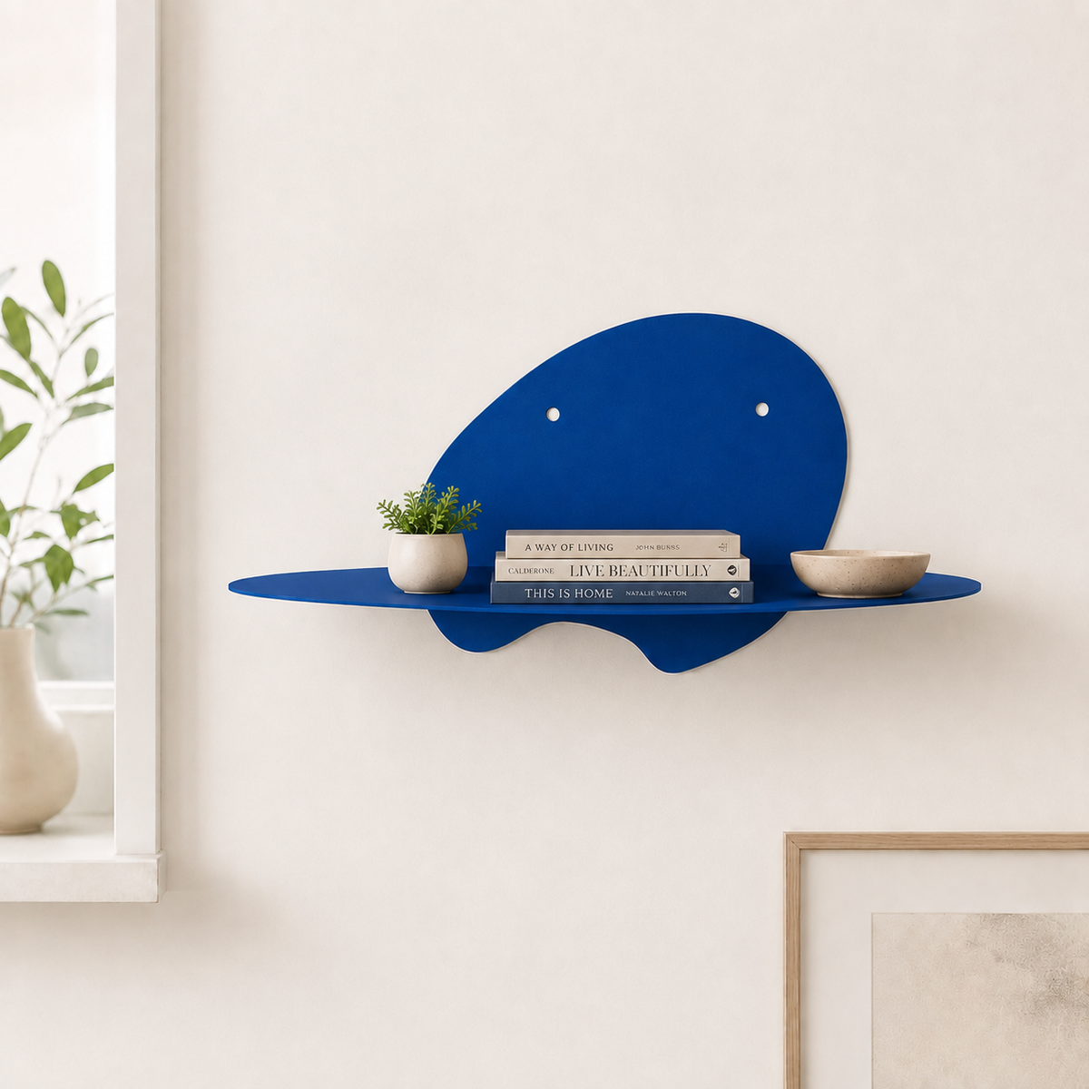  abstract metal floating wall shelf with curved back panel displaying a small succulent and notebook