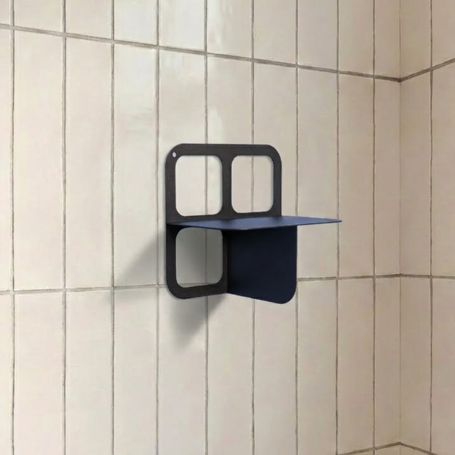 Black wall-mounted shelf on a tiled bathroom wall