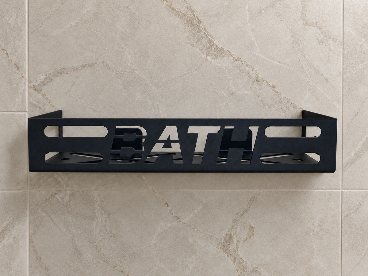 Black metal bathroom wall shelf with cutout BATH lettering, geometric openings and wall-mounted brackets