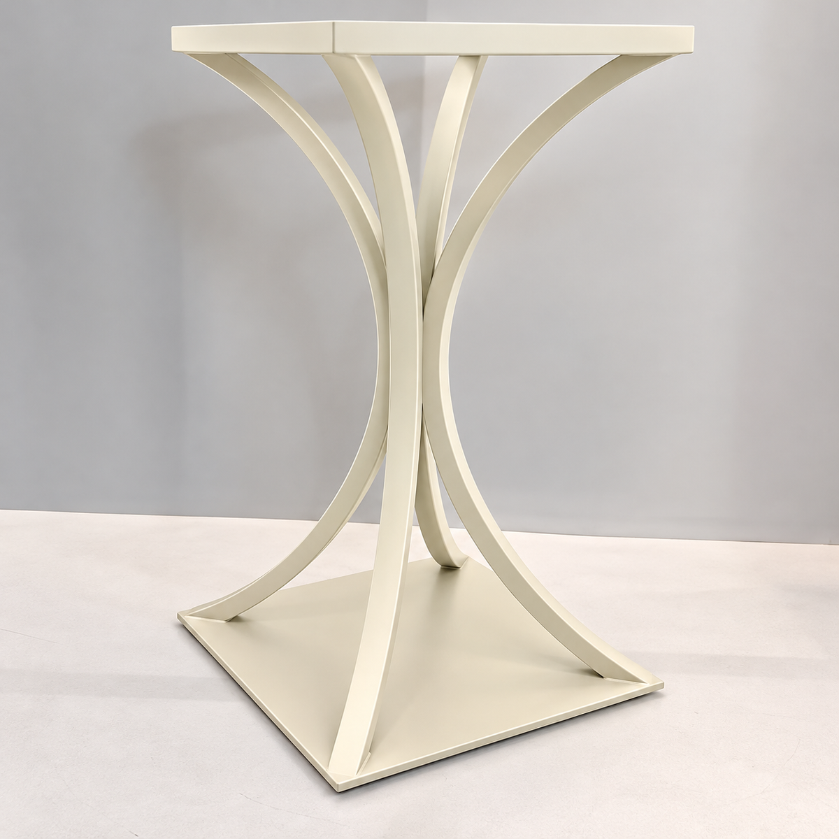 An off-white wooden side table with a sculptural, curved X-shaped pedestal base and a square top, set against a neutral gray studio background.