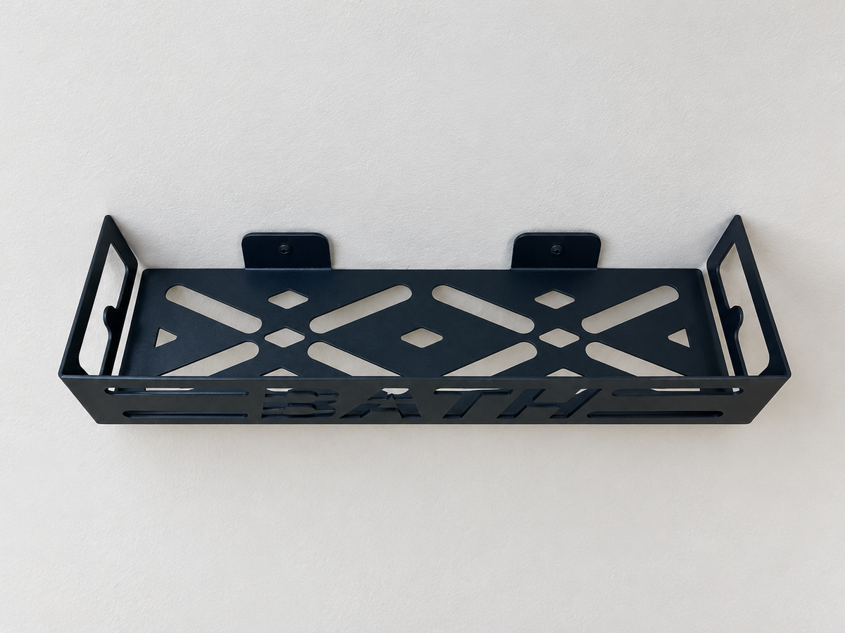 Black metal bathroom wall shelf with cutout BATH lettering, geometric openings and wall-mounted brackets