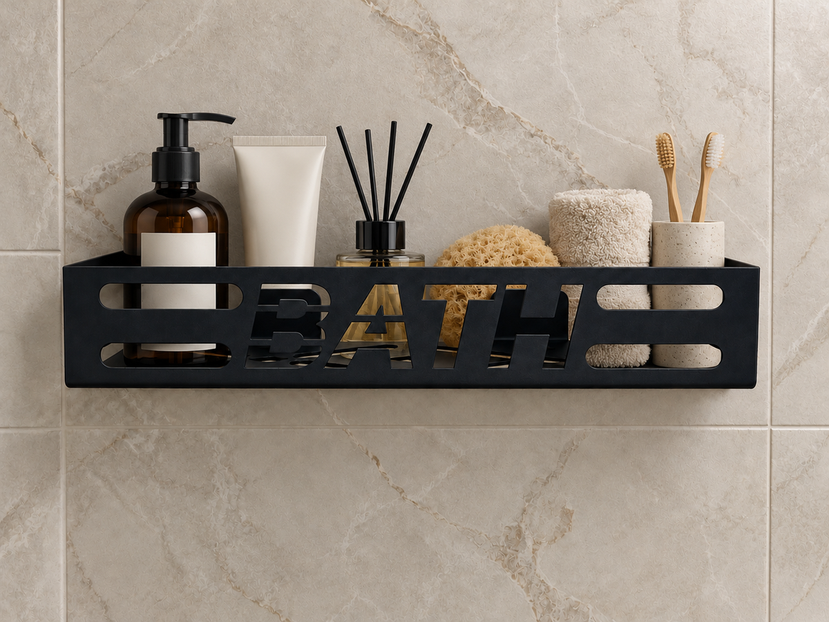 Black metal bathroom wall shelf with cutout BATH lettering, geometric openings and wall-mounted brackets