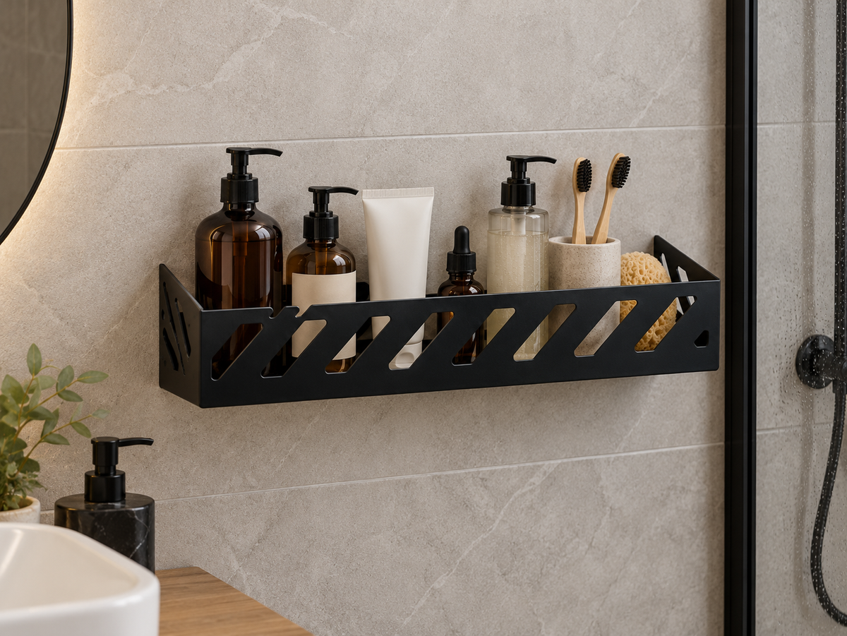 Black metal bathroom wall shelf with geometric cutouts holding toiletries, soap dispensers and toothbrushes
