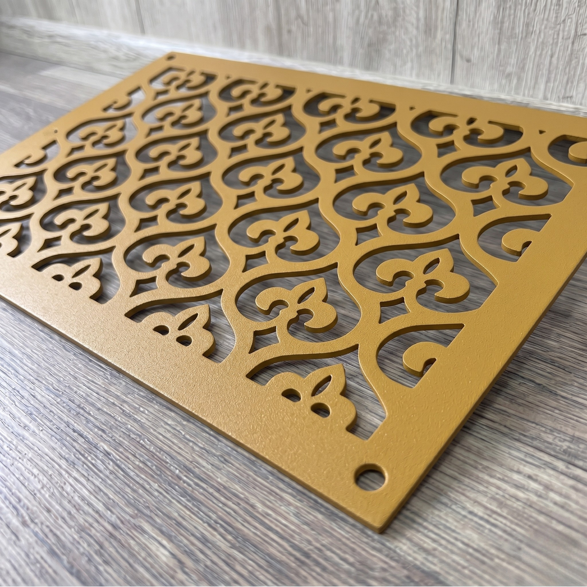Victorian decorative metal vent cover with ornate laser-cut grille pattern