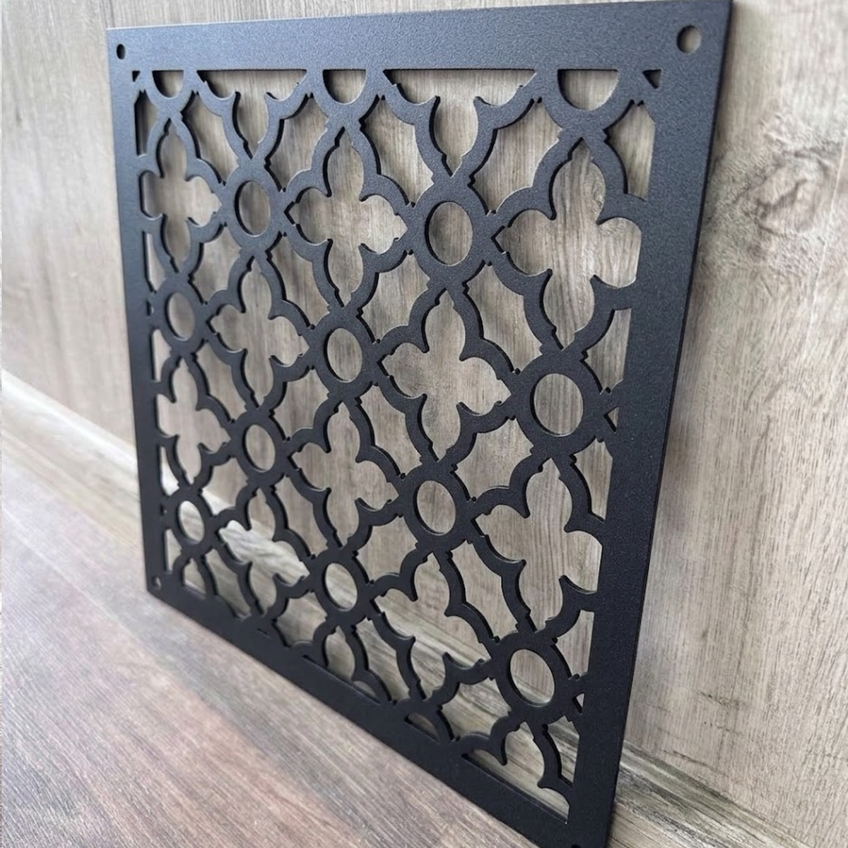Victorian decorative metal vent cover with ornate laser-cut grille pattern