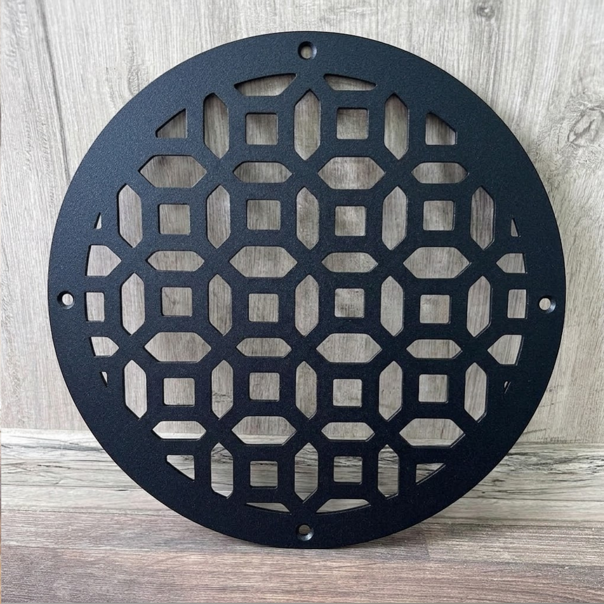Round decorative metal vent cover with custom laser-cut pattern