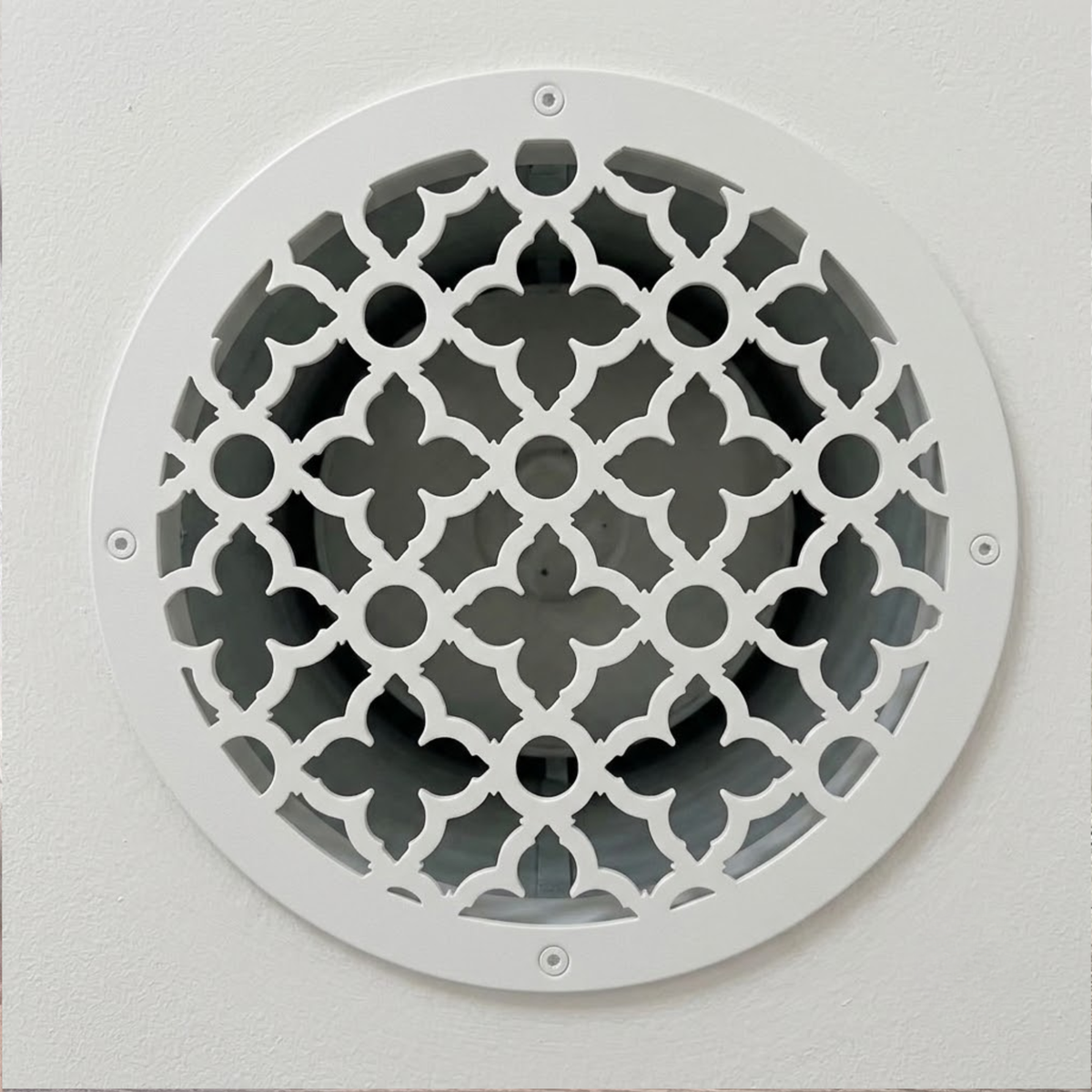 Round decorative metal vent cover with custom laser-cut pattern