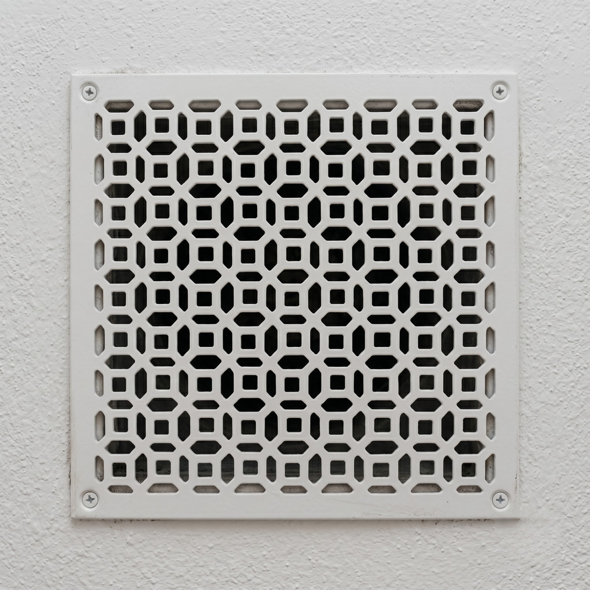 Large custom metal vent cover with decorative laser-cut geometric patterns